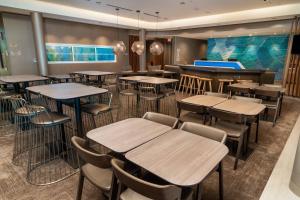 a restaurant with tables and chairs and a bar at SpringHill Suites by Marriott Newark Fremont in Newark