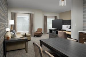 Habitación de hotel con mesa de comedor y sala de estar. en Residence Inn by Marriott Jacksonville Downtown en Jacksonville