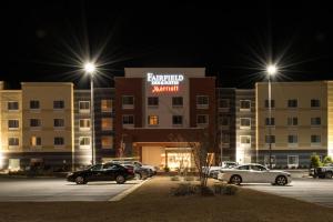 a parking lot in front of a hotel at night at Fairfield Inn & Suites by Marriott Atmore in Atmore