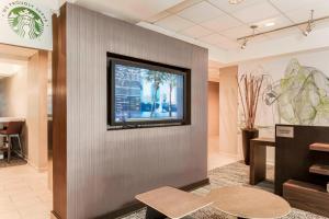 a lobby with a television on the wall at Courtyard by Marriott Orlando Lake Mary North in Lake Mary