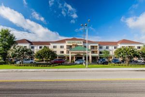 a large building with a parking lot in front of it at Courtyard Florence South Carolina in Florence