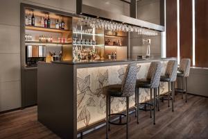 a bar with stools in a room at AC Hotel Ponferrada by Marriott in Ponferrada