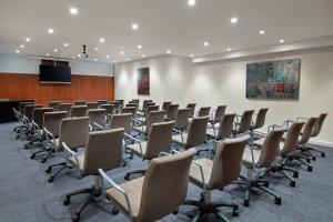 a room with rows of chairs and a podium at AC Hotel Ponferrada by Marriott in Ponferrada