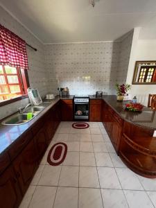 a kitchen with a sink and a stove at Sunset Cove Villa in Grand'Anse Praslin +28 photos