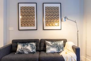 a living room with a couch and two pictures on the wall at Bilbao Old Town VI by Aston Rentals in Bilbao