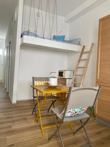 a dining room with a yellow table and chairs at La Casa di Szà in Otranto +30 photos