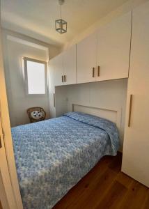 1 dormitorio con 1 cama y armarios blancos en La Casa di Szà, en Otranto