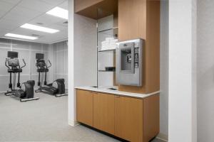 a waiting room with a gym with machines at SpringHill Suites by Marriott Raleigh Apex in Apex