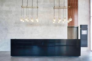 a kitchen with a black counter and several chandeliers at AC Hotel by Marriott Veracruz in Veracruz