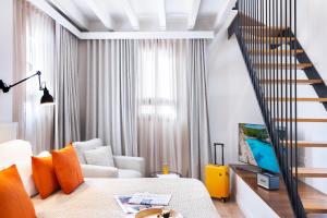 a living room with a bed and a staircase at Samaritana Suites in Palma de Mallorca