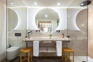 a bathroom with a sink and a mirror at Samaritana Suites in Palma de Mallorca