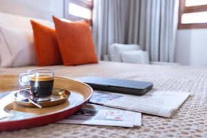 a tray with a cup of coffee on a bed at Samaritana Suites in Palma de Mallorca
