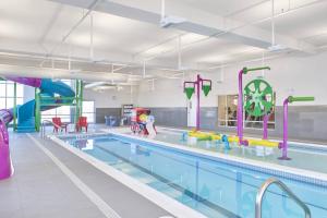 a large swimming pool with a water park at TownePlace Suites by Marriott Medicine Hat in Medicine Hat