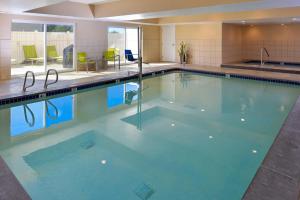 a large swimming pool with blue water at Fairfield Inn Salt Lake City Layton in Layton