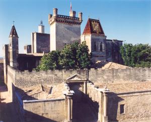 an old building with a clock tower on top of it at Le Mas du Berger in Saint-Quentin-la-Poterie