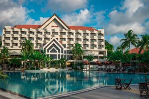 a hotel with a pool in front of it at Miri Marriott Resort & Spa in Miri