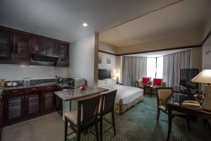 a hotel room with a bed and a kitchen at Miri Marriott Resort & Spa in Miri