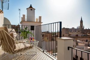a balcony with a table and chairs on a building at Samaritana Suites in Palma de Mallorca