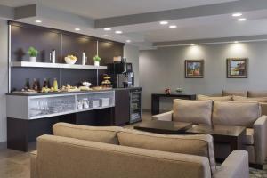 a living room with a couch and chairs and a table at Delta Hotels by Marriott Beausejour in Moncton