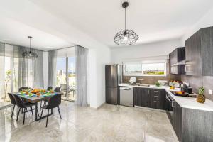 a kitchen and dining room with a table and chairs at Villa Alasia in Paralimni