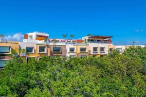 a building on top of a hill with trees at Aloft Tulum in Tulum