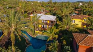 an aerial view of a resort with a pool and palm trees at Domus Villas in Pipa