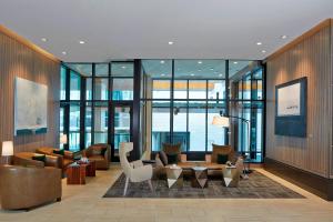 a lobby with couches and chairs in a building at AC Hotel by Marriott Seattle Bellevue/Downtown in Bellevue
