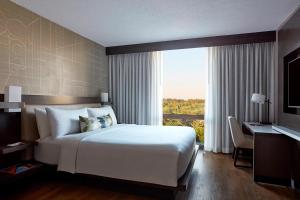 a bedroom with a large white bed and a window at Bethesda Marriott in Bethesda +53 photos