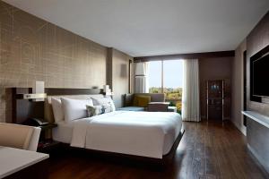 a bedroom with a large white bed and a large window at Bethesda Marriott in Bethesda