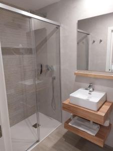 a bathroom with a shower and a sink at Nerja VG Hostal Boutique in Nerja