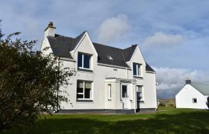 a large white house with a black roof at Croft@42 in Vatsker