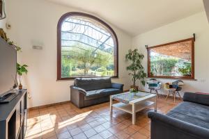 a living room with a couch and a table at Bouganville Home Mondello in Mondello