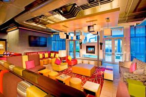 a living room with colorful furniture and a fireplace at Aloft Mount Laurel in Mount Laurel