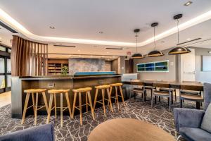 a bar in a hotel room with bar stools at SpringHill Suites by Marriott Oakland Airport in Oakland