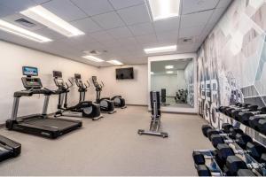 a gym with treadmills and elliptical machines at SpringHill Suites by Marriott Oakland Airport in Oakland