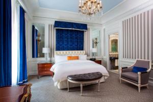 a bedroom with a king sized bed and a chair at The St. Regis New York in New York