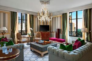 a living room with a couch and a chandelier at The St. Regis New York in New York