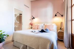 a bedroom with a bed with a book on it at Samaritana Suites in Palma de Mallorca