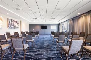 a conference room with chairs and a projection screen at Fairfield by Marriott Inn & Suites San Francisco Airport Oyster Point Area in South San Francisco