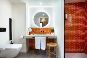 a bathroom with a sink and a mirror at Samaritana Suites in Palma de Mallorca