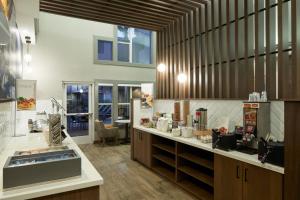 Residence Inn San Diego Carlsbad في كارلسباد: مطبخ كبير مع حوض ومكتب