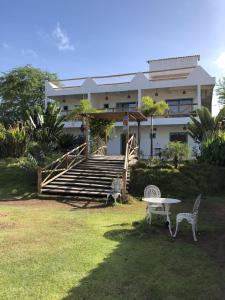 a house with a table and chairs in front of it at Pousada farol in Areia Branca