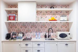 a kitchen with a sink and a microwave at Samaritana Suites in Palma de Mallorca