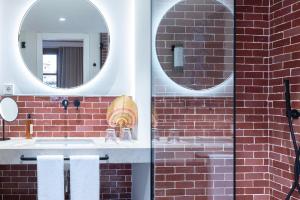 a bathroom with a sink and a mirror at Samaritana Suites in Palma de Mallorca