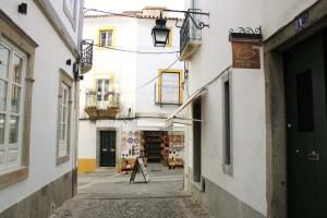 an alley in an old town with buildings at Mont' Sobro House in Évora