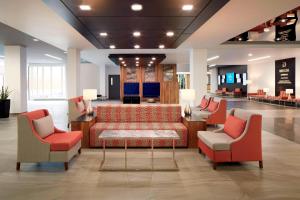 a lobby with a couch and chairs in a mall at Delta Hotels by Marriott Trois Rivieres Conference Centre in Trois-Rivières