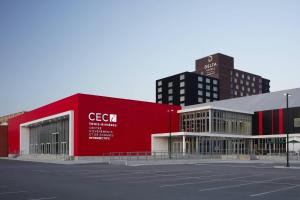 a red building in a city with tall buildings at Delta Hotels by Marriott Trois Rivieres Conference Centre in Trois-Rivières