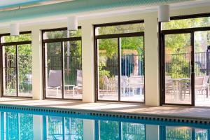 a house with a swimming pool and windows at SpringHill Suites by Marriott Peoria in Peoria