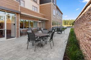 a patio with tables and chairs next to a building at Fairfield by Marriott Inn & Suites Seattle Poulsbo in Poulsbo