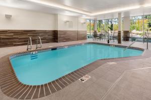 a swimming pool in a hotel room with a large pool at Fairfield by Marriott Inn & Suites Seattle Poulsbo in Poulsbo